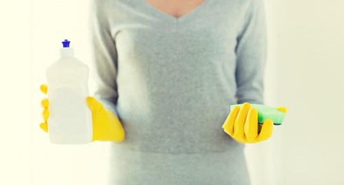 Cleaner vacuuming a mattress for dust removal in Carshalton